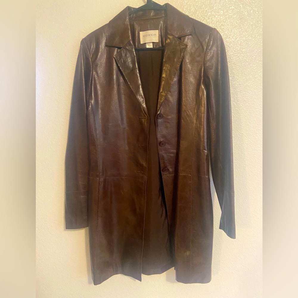leather jacket . Long and is in brown